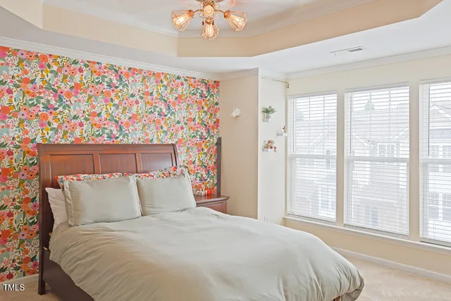 a bedroom with a bed and flat screen tv