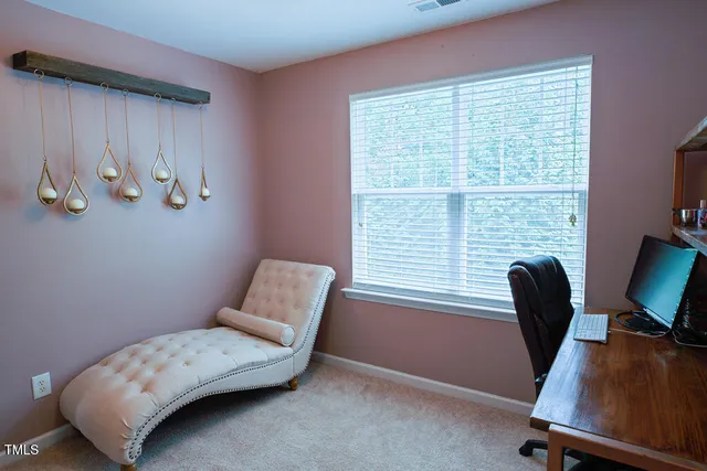 an aerial view of a house with a swimming pool and outdoor seating