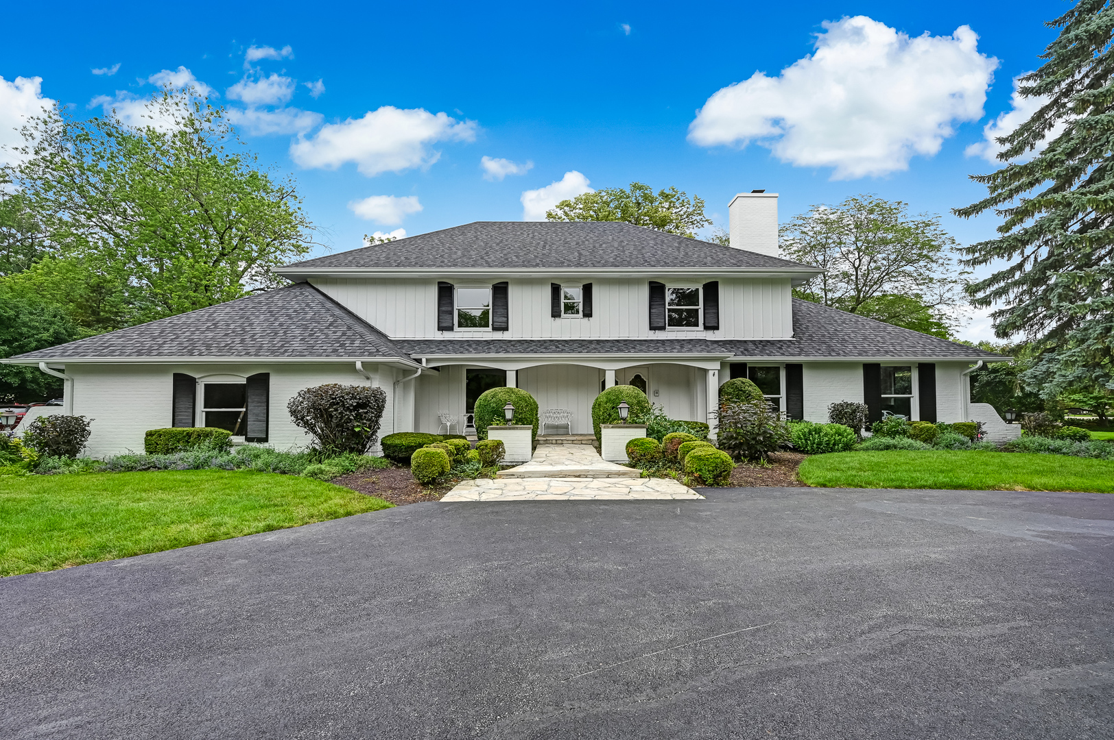 a front view of a house with garden