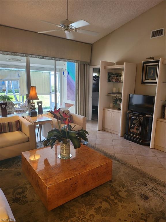 843 Marblehead Drive, Unit I3 Naples, FL 34104 - Photo 17 of 35 a living room with furniture and a fireplace