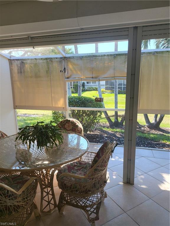 843 Marblehead Drive, Unit I3 Naples, FL 34104 - Photo 18 of 35 a dining room with furniture and a floor to ceiling window