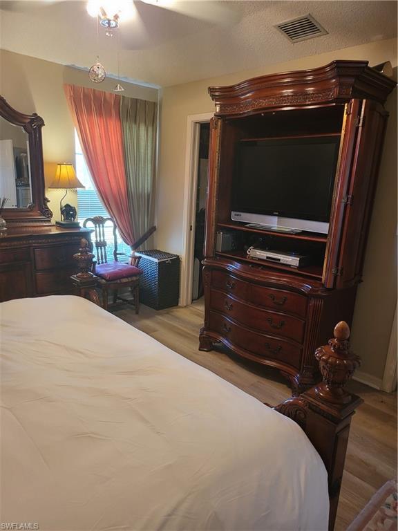 843 Marblehead Drive, Unit I3 Naples, FL 34104 - Photo 22 of 35 a bedroom with a bed and a television