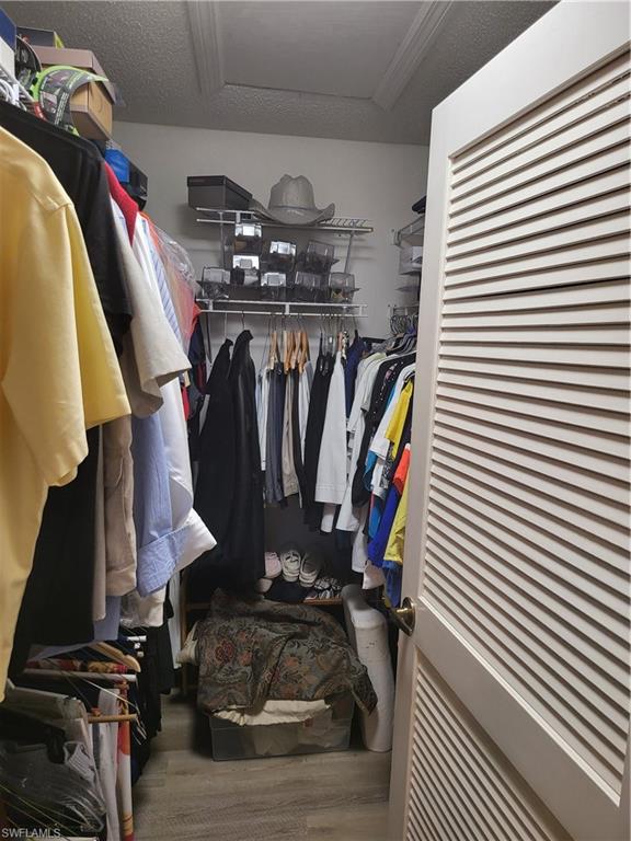 843 Marblehead Drive, Unit I3 Naples, FL 34104 - Photo 23 of 35 a view of walk in closet with clothes and shoes