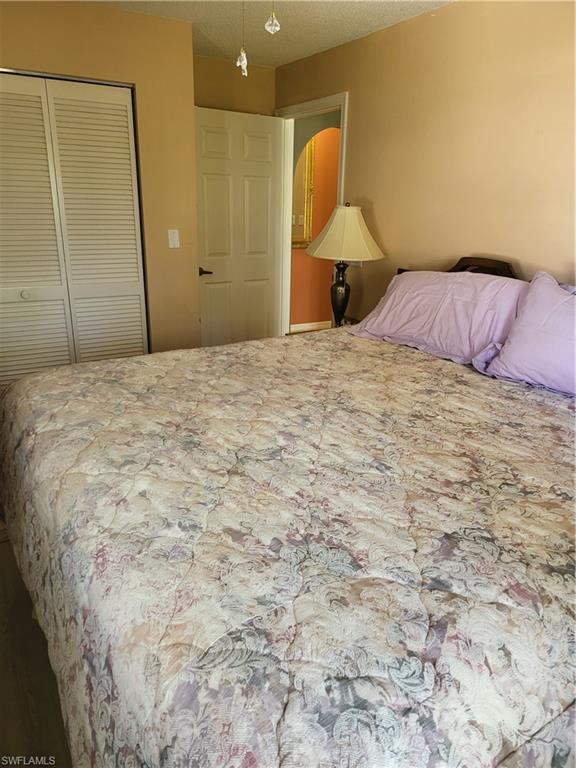843 Marblehead Drive, Unit I3 Naples, FL 34104 - Photo 3 of 35 a bedroom with a bed and a mirror