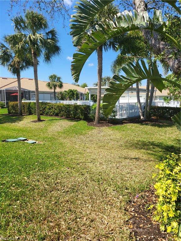 843 Marblehead Drive, Unit I3 Naples, FL 34104 - Photo 35 of 35 a view of a backyard with a garden and trees