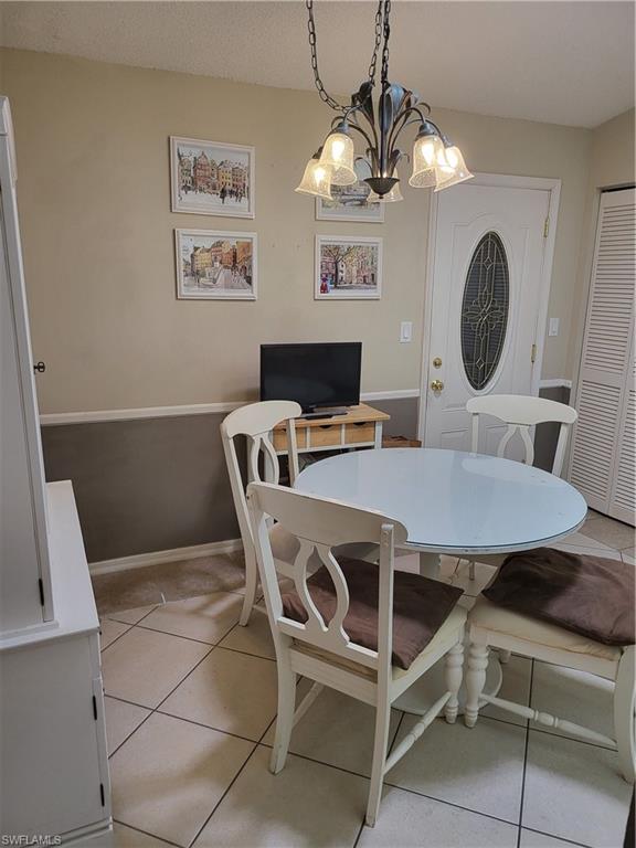 843 Marblehead Drive, Unit I3 Naples, FL 34104 - Photo 9 of 35 a dining room with a table and chairs
