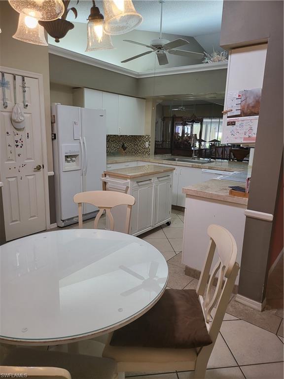 843 Marblehead Drive, Unit I3 Naples, FL 34104 - Photo 10 of 35 a kitchen with stainless steel appliances granite countertop a sink and cabinets