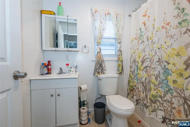a white toilet sitting next to a bathroom sink