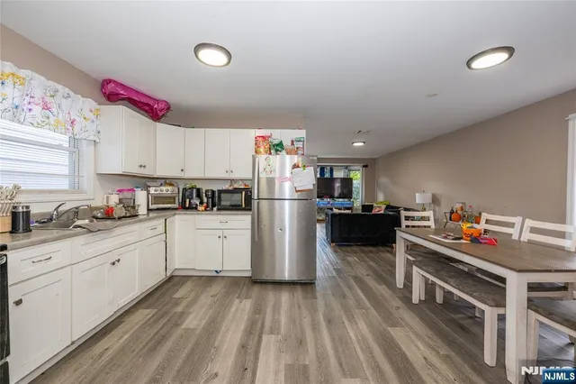 a kitchen with refrigerator and cabinets