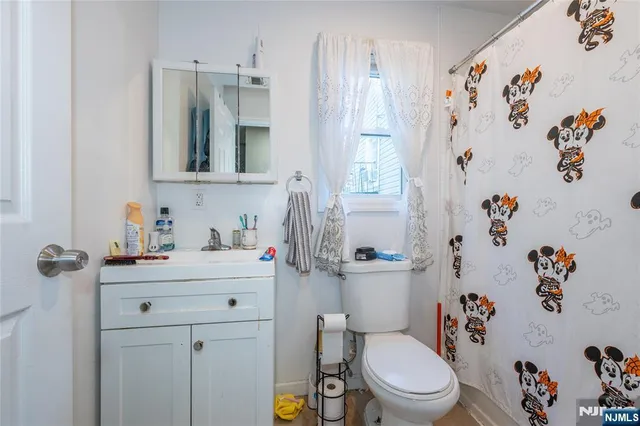 a bathroom with a sink a toilet and a mirror