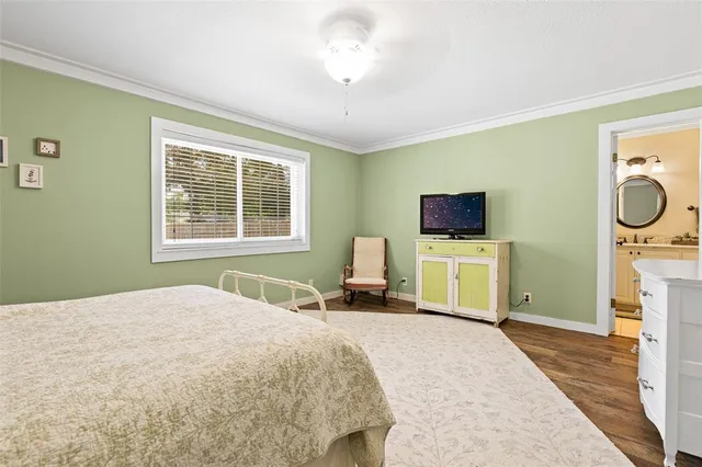 a bedroom with a bed a flat screen tv and island