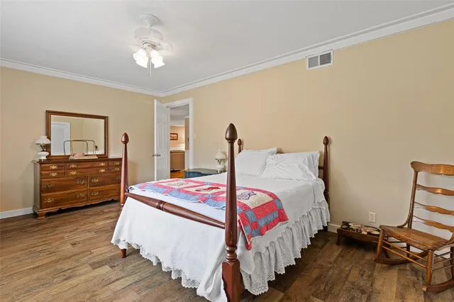 a bedroom with a bed and a dresser