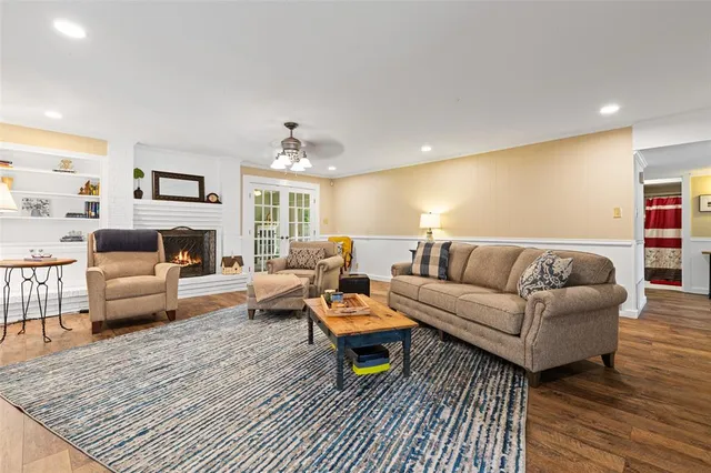 a living room with furniture and a wooden floor