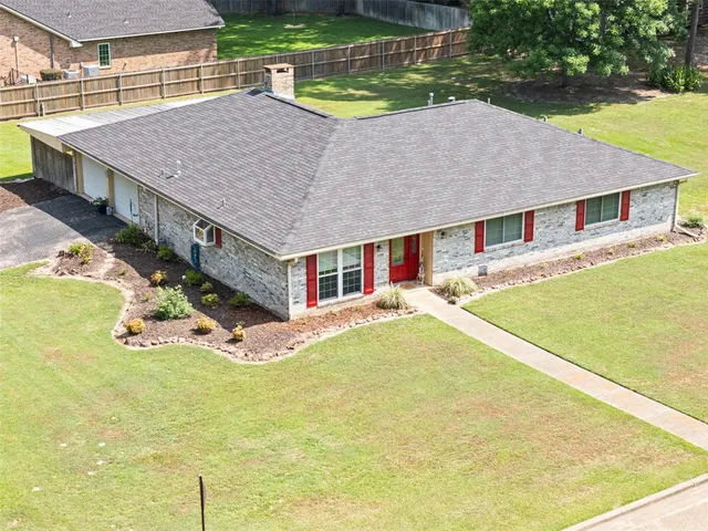 a aerial view of a house with swimming pool and yard