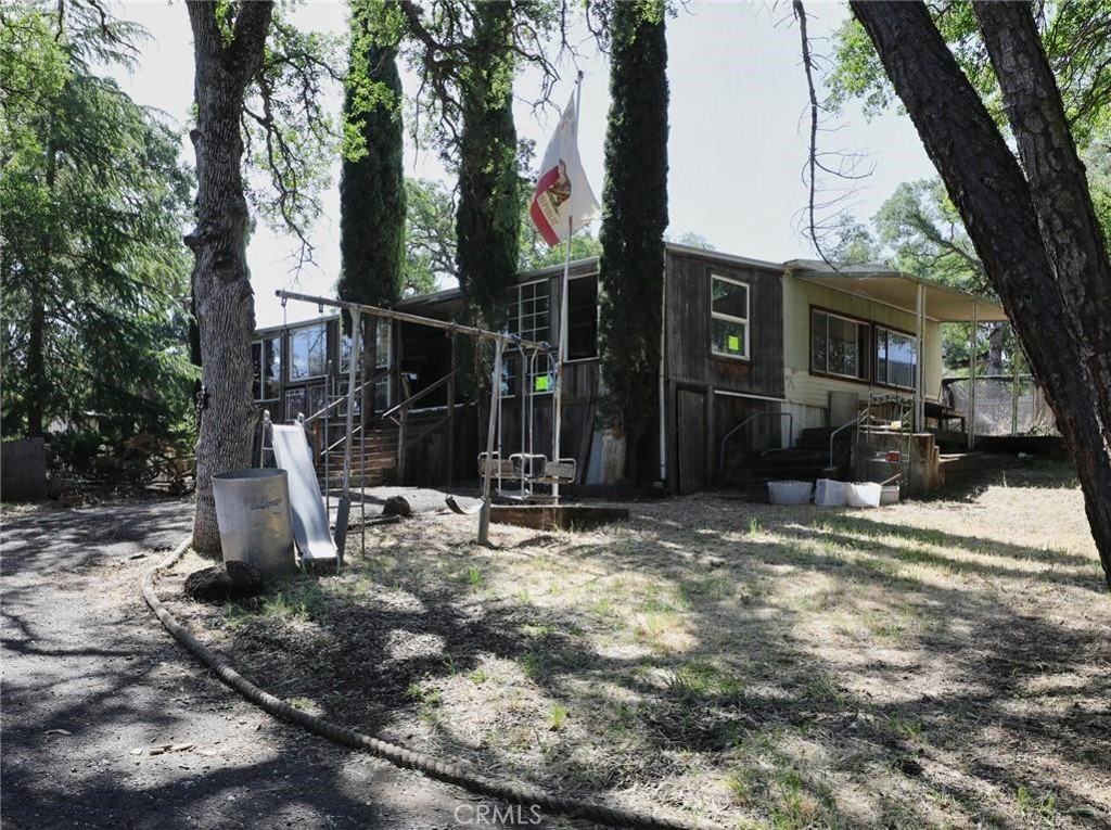 a view of a backyard with table and chairs and a fire pit