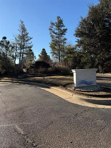 a view of street with wooden fence