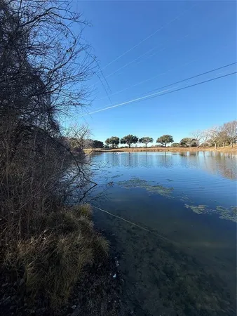 a view of ocean with green space