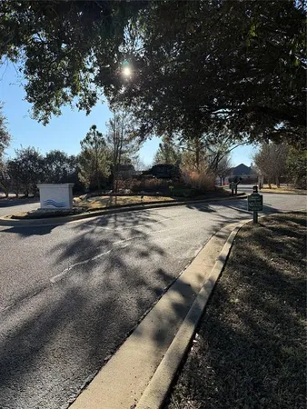 a view of a yard with wooden fence