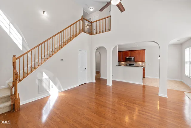 a view of an empty room with window and fire place