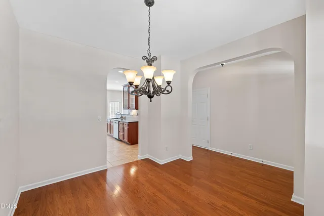 a view of a room with wooden floor and ceiling fan