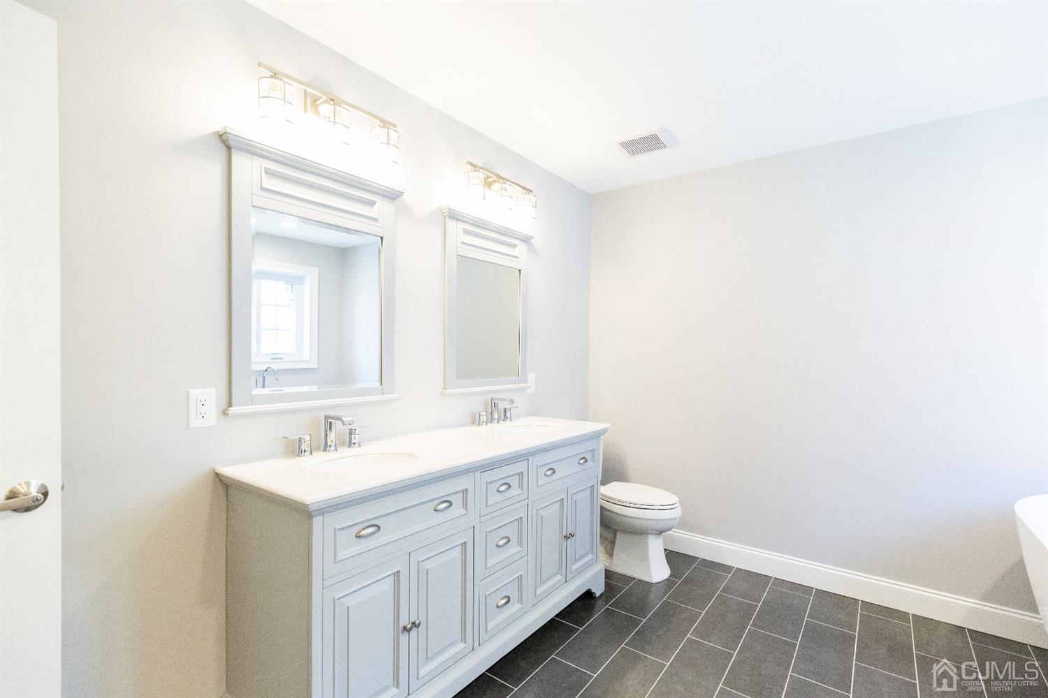 20 Winthrop Road Edison, NJ 08817 - Photo 44 of 55 a spacious bathroom with a double vanity sink toilet and a mirror