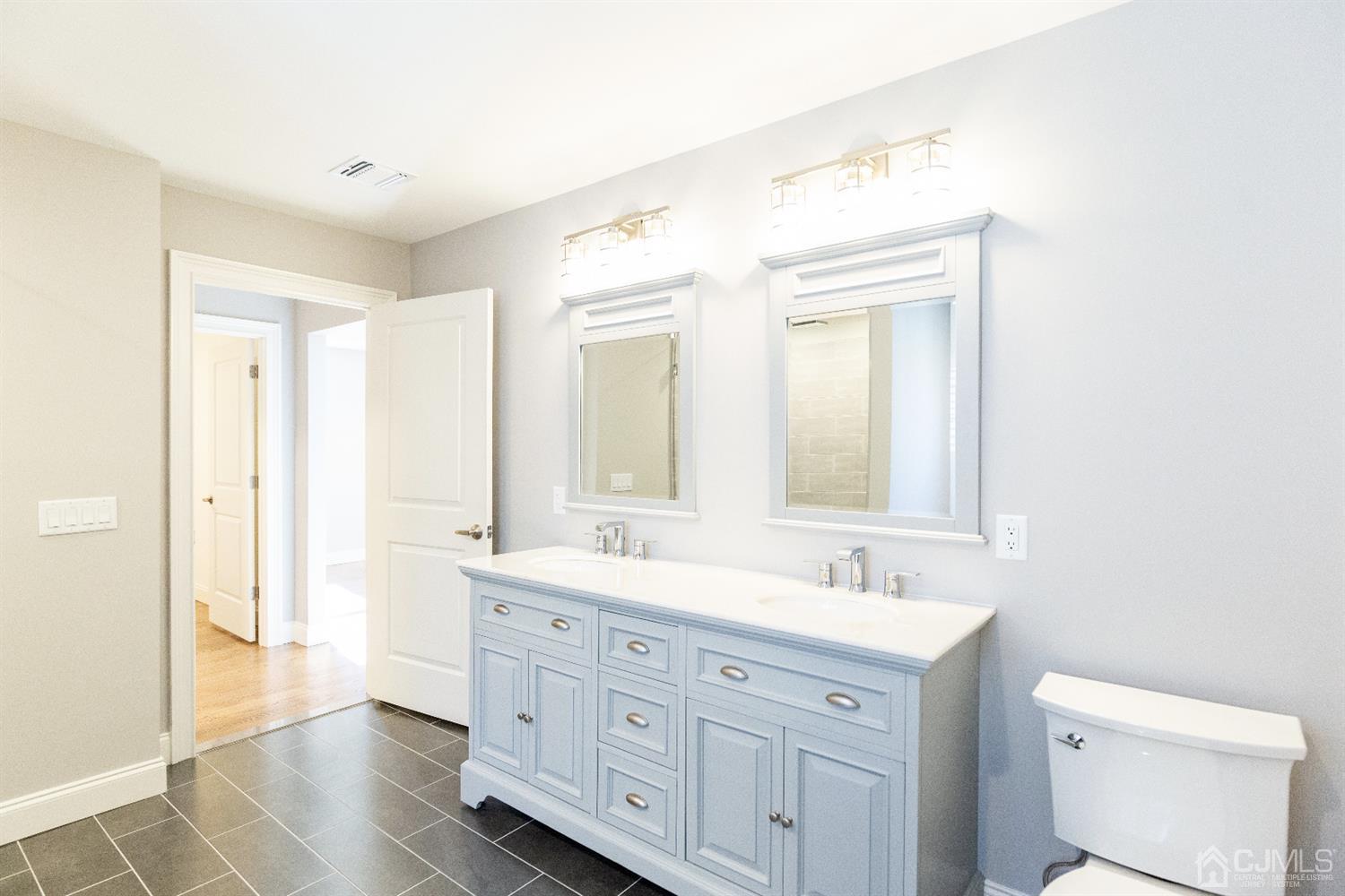 20 Winthrop Road Edison, NJ 08817 - Photo 46 of 55 a spacious bathroom with a double vanity sink a mirror and a toilet
