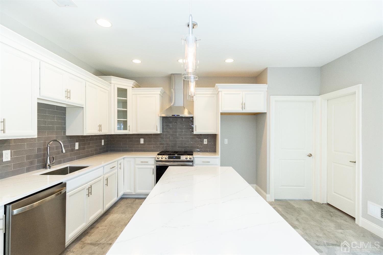 20 Winthrop Road Edison, NJ 08817 - Photo 9 of 55 a kitchen with a sink a counter top space stainless steel appliances and cabinets