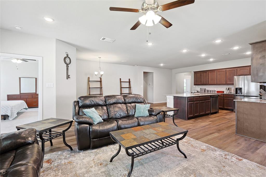 808 Feather Edge Drive Springtown, TX 76082 - Photo 19 of 40 a living room with furniture kitchen view and a chandelier
