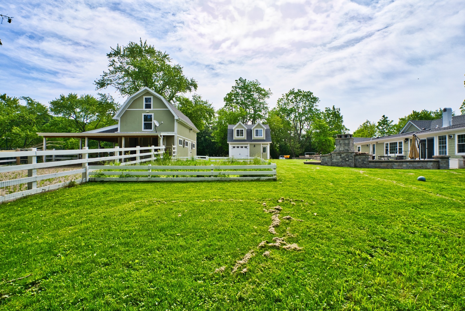 33W878 Army Trail Road Wayne, IL 60184 - Photo 13 of 36 a front view of a house with a yard table and chairs