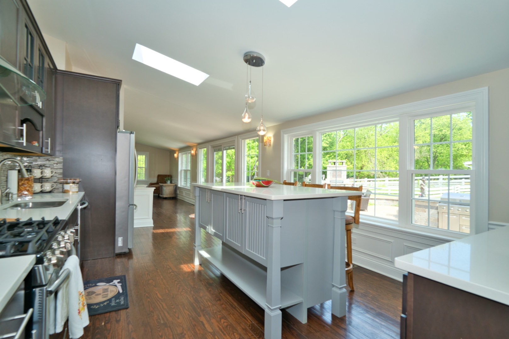 33W878 Army Trail Road Wayne, IL 60184 - Photo 21 of 36 a living room with furniture a large window and wooden floor