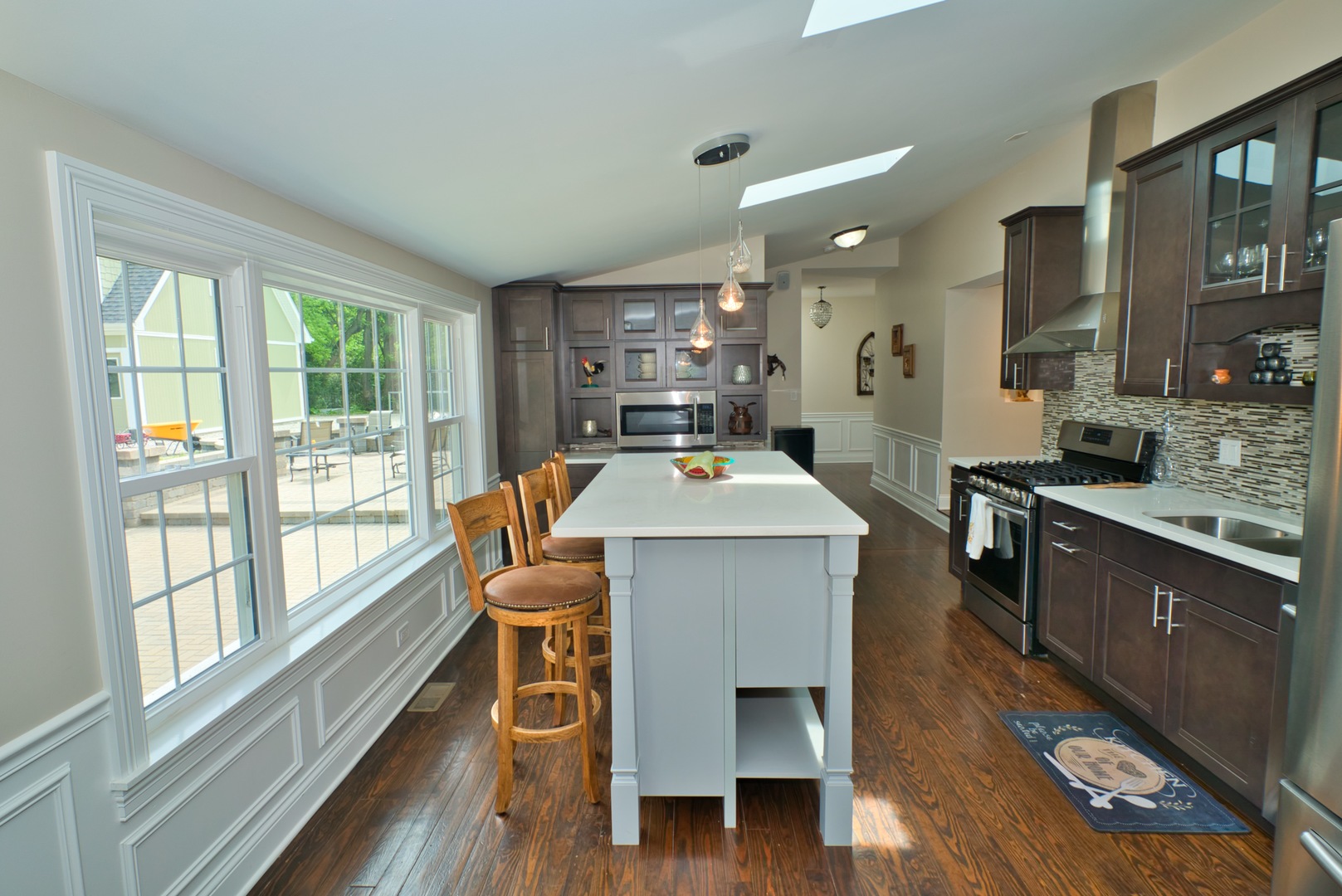 33W878 Army Trail Road Wayne, IL 60184 - Photo 23 of 36 a kitchen with a table chairs sink and wooden floor