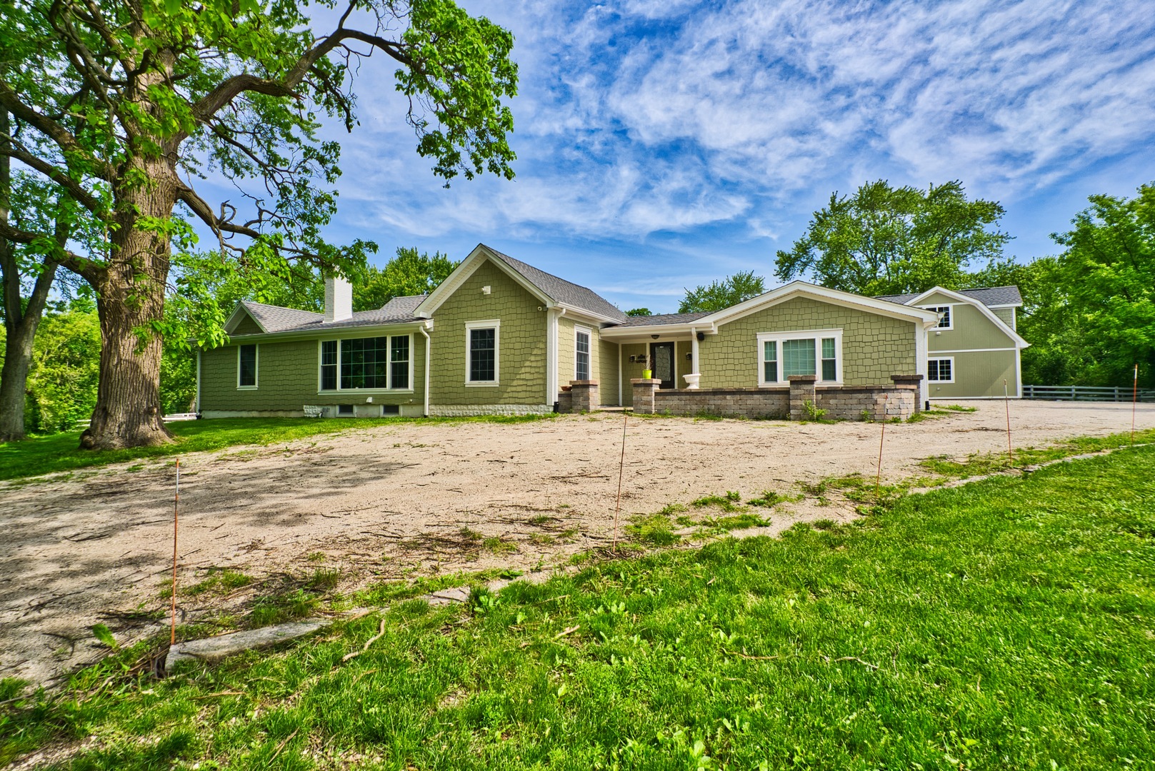 33W878 Army Trail Road Wayne, IL 60184 - Photo 5 of 36 a front view of a house with a garden
