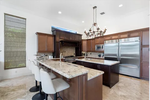 a living room with furniture a flat screen tv and a chandelier