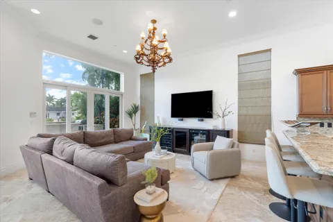 a spacious bedroom with a bed and a chandelier