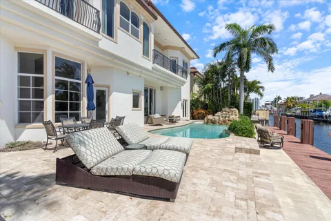 a bedroom with a bed painting on wall and a large window