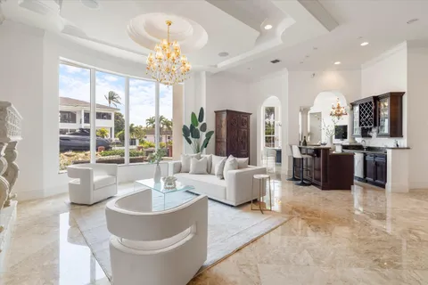 a open kitchen with stainless steel appliances granite countertop a stove top oven a sink dishwasher and a refrigerator with wooden cabinets