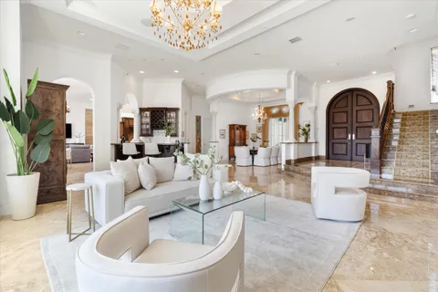 a kitchen with kitchen island granite countertop a sink stainless steel appliances and chandelier