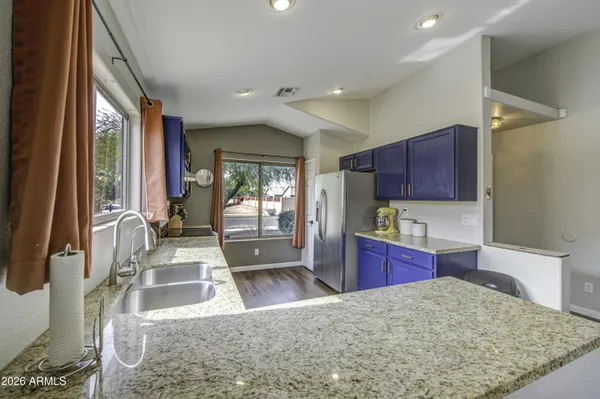 a kitchen with a sink a counter top space and a large window