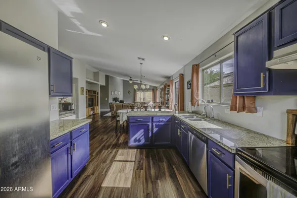 a kitchen with stainless steel appliances granite countertop a refrigerator and a sink