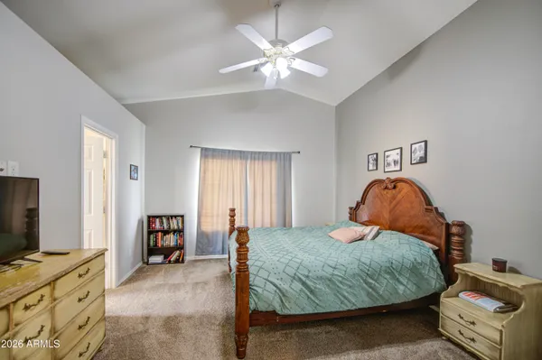 a bedroom with a bed and a television