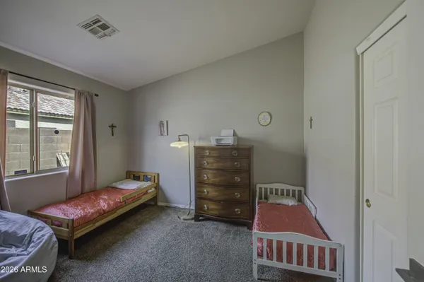a view of bedroom with cabinets and dresser