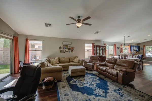 a living room with furniture ceiling fan and a window