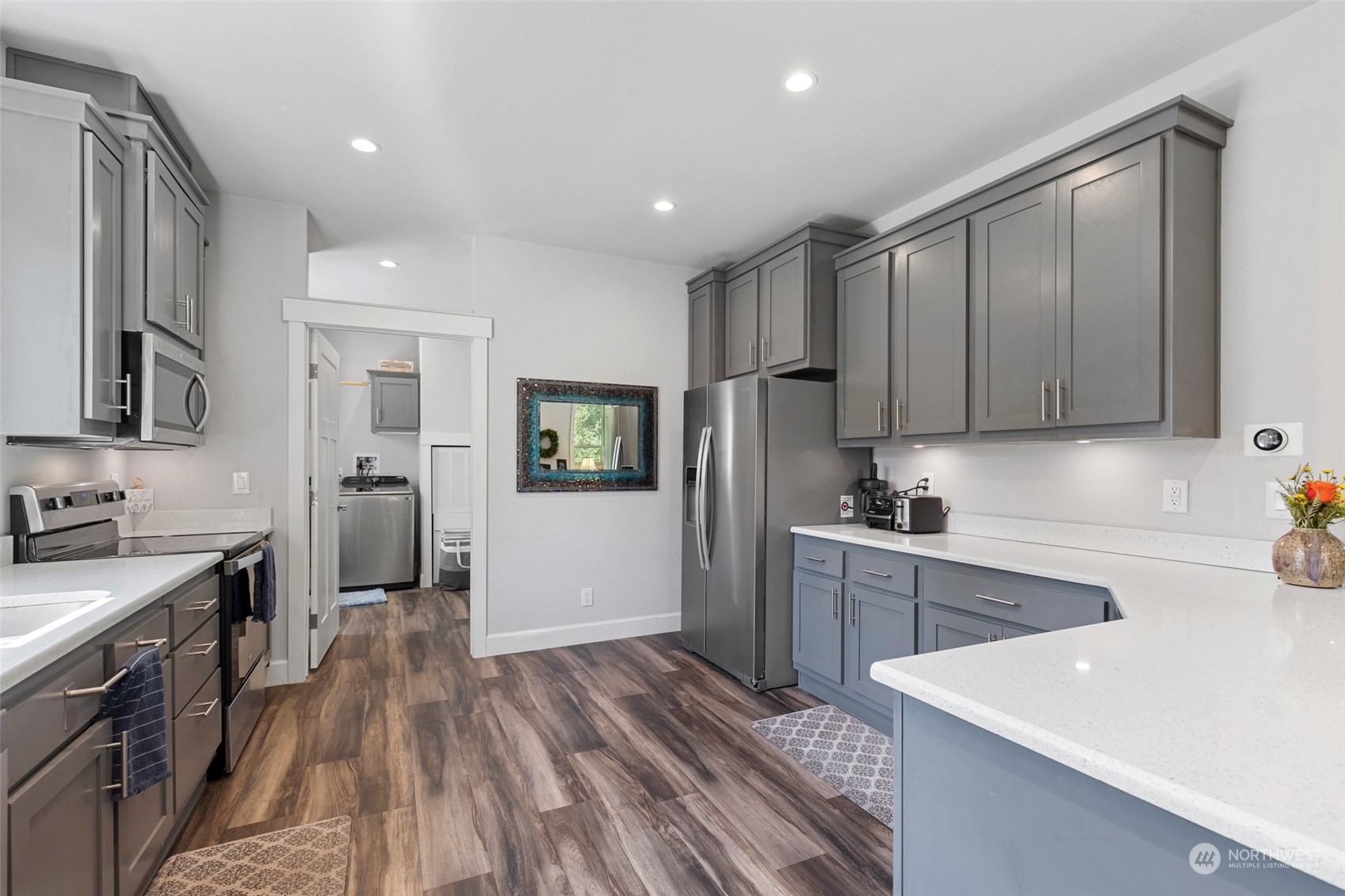 6303 Kirkhill Road Clinton, WA 98236 - Photo 13 of 40 a kitchen with a sink a refrigerator and cabinets