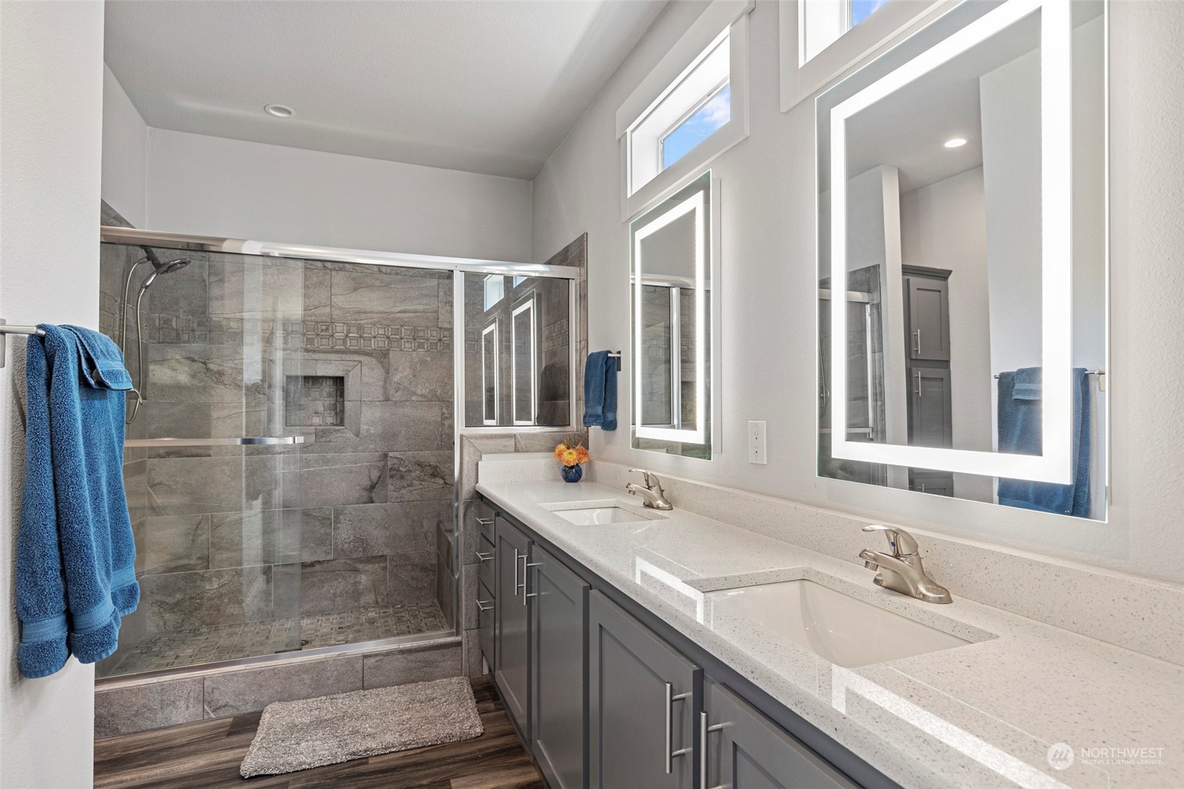 6303 Kirkhill Road Clinton, WA 98236 - Photo 26 of 40 a bathroom with a shower sink and mirror