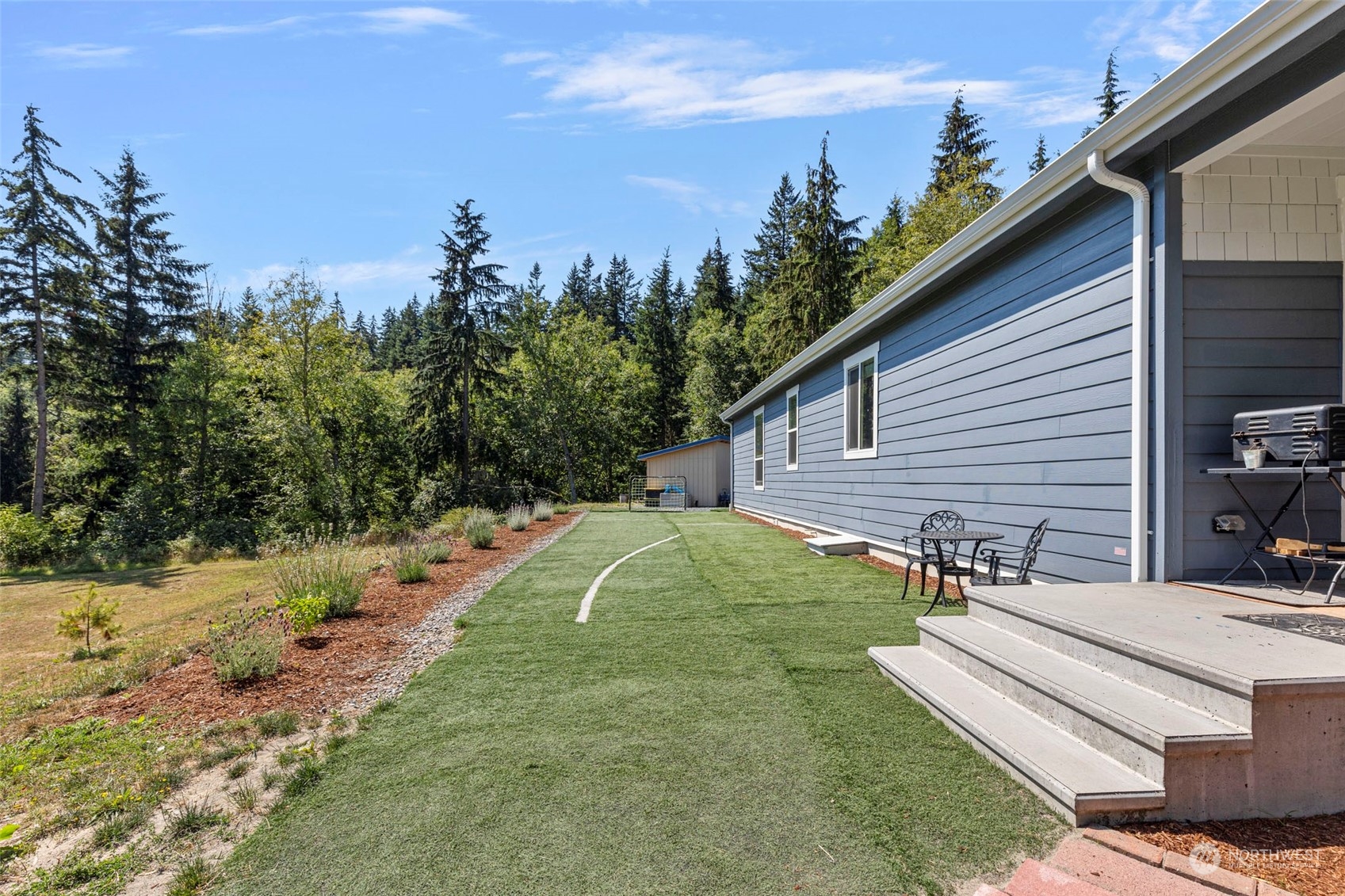 6303 Kirkhill Road Clinton, WA 98236 - Photo 31 of 40 a view of a backyard with plants and a patio