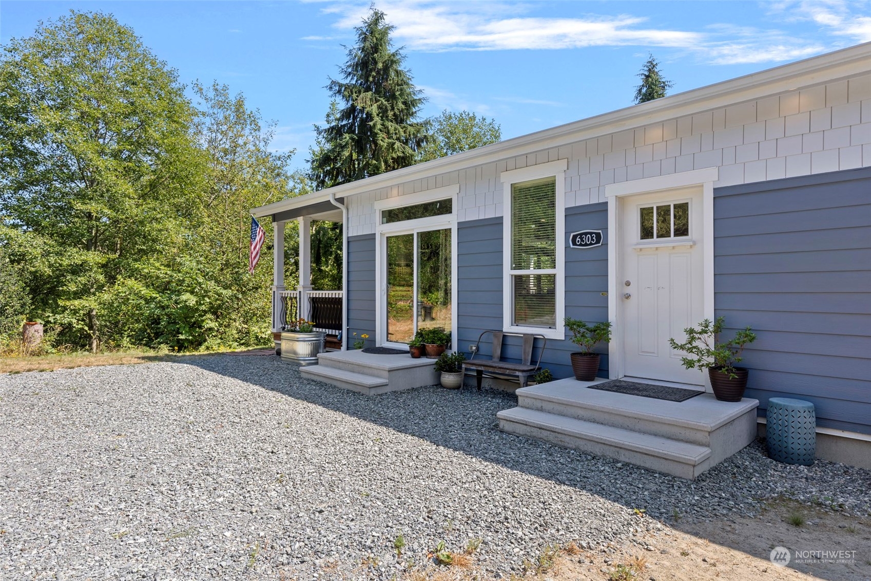 6303 Kirkhill Road Clinton, WA 98236 - Photo 5 of 40 a front view of a house with outdoor seating and trees