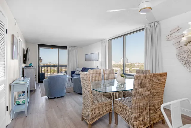a dining room with furniture a rug and wooden floor