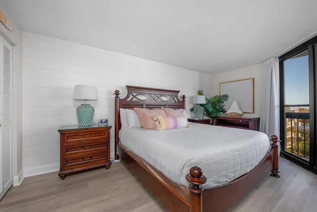 a bedroom with a bed a dresser and mirror