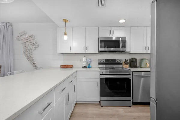 a kitchen with stainless steel appliances granite countertop a stove and a sink