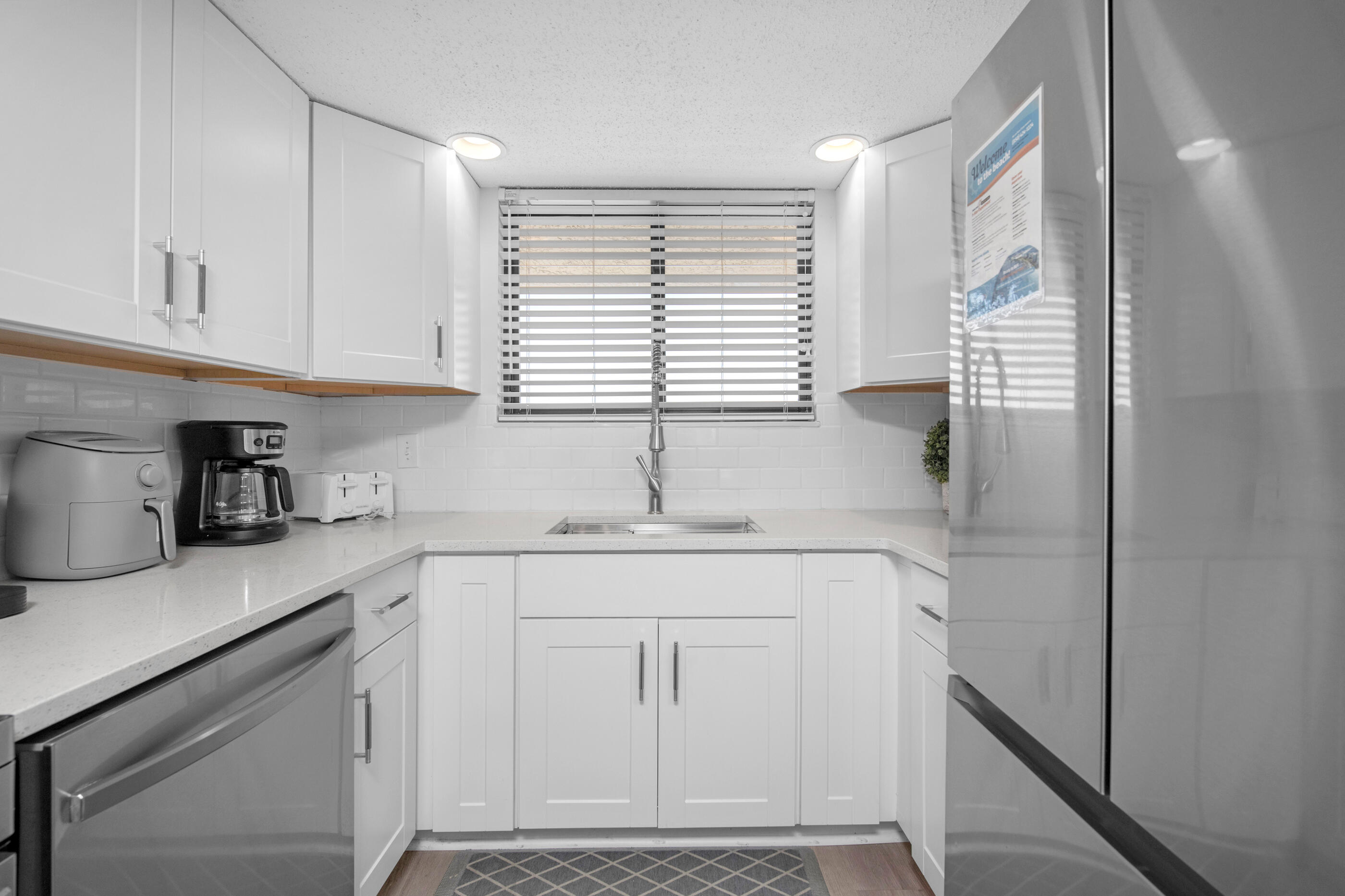 1040 Highway 98, Unit 518 Destin, FL 32541 - Photo 18 of 40 a kitchen with white cabinets and window